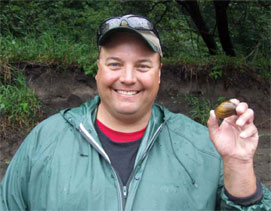 Scott Gritters of the Iowa Department of Natural Resources holds a Higgins eye pearlymussel that was found 19 miles below the stocking site, after the devastating 2008 floods.